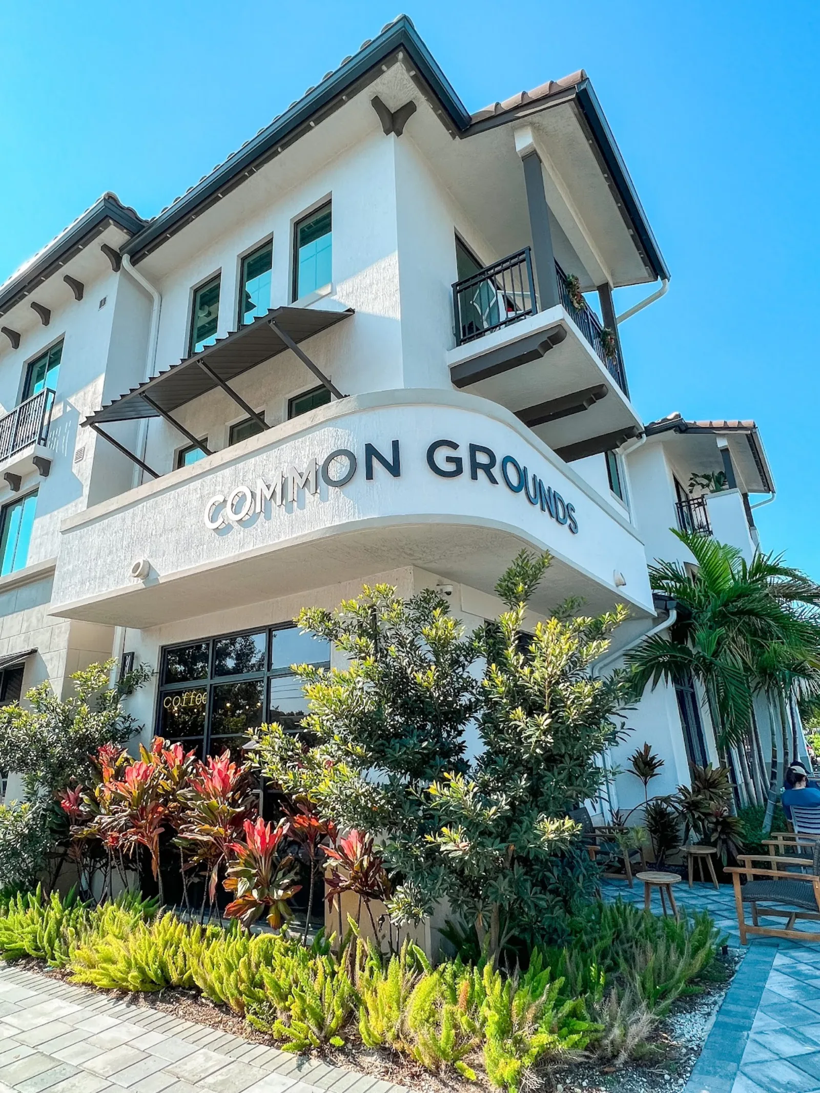 Common Grounds Brew & Roastery — Mediterranean-style storefront on S Dixie Hwy